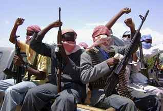 Somali Islamist militants hold their weapons as they ride on a pick-up truck on the outskirts of Mogadishu