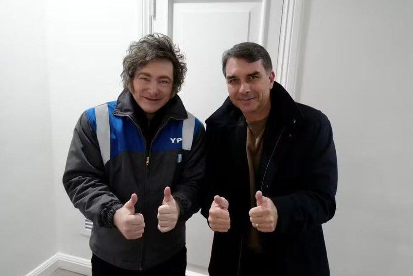 Javier Milei e Flávio Bolsonaro posam para foto em reunião política