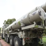 Militares indianos observam um lançador de mísseis BrahMos em exposição ao ar livre. (Foto: rt.com)